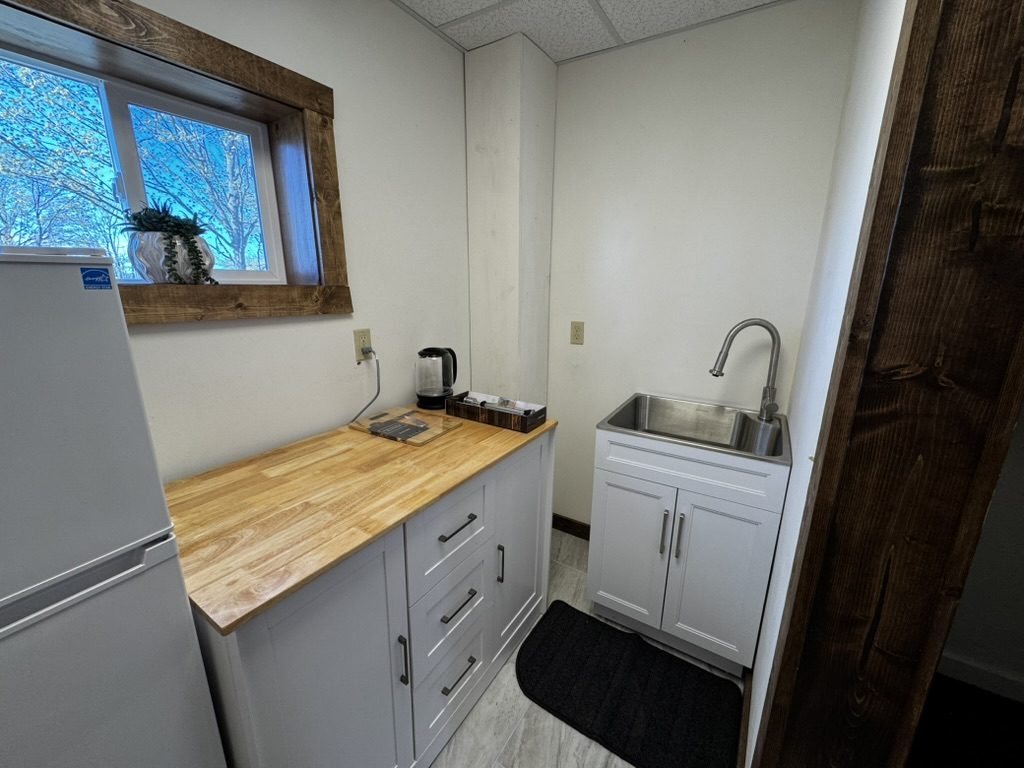 Kitchenette showing sink and butcher block counter